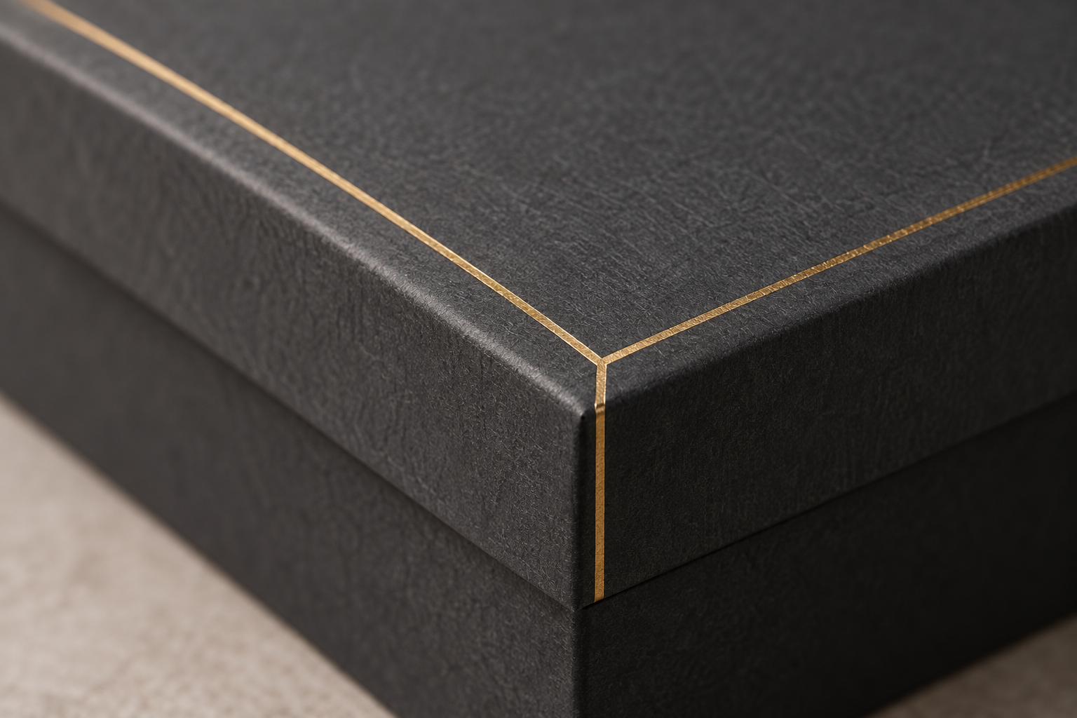 Close-up of gold foil on a dark gift box, illustrative image